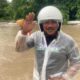 seorang warga berada di lokasi banjir banyuwangi selatan